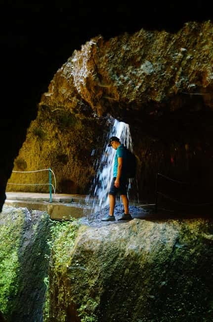 From Funchal: Levada Nova Hiking Tour with stopover at beach - Stone bridges, flowers, and the waterfall-and-tunnel moments